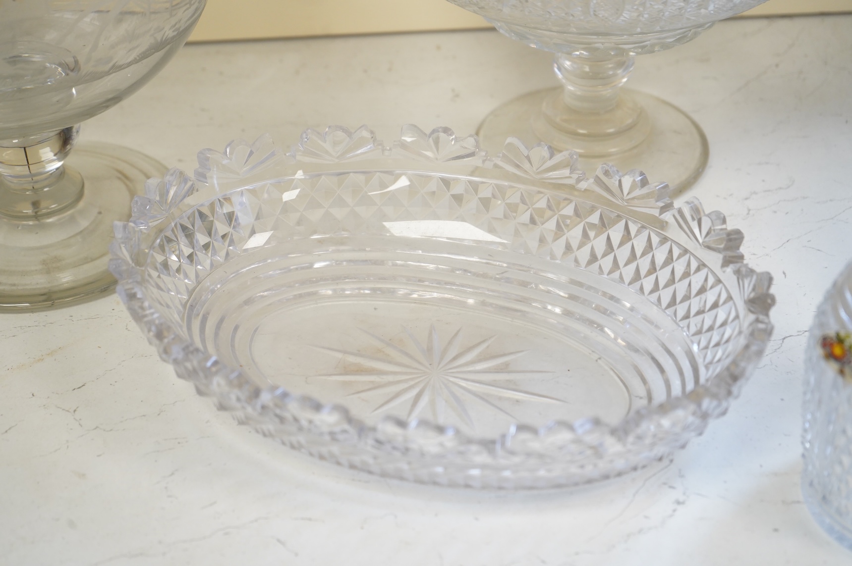 Two footed glass bowls engraved with racing and hunting scenes, an early 19th century oval cut glass fruit bowl, another, modern, together with a small Regency mallet shaped decanter, with an enamel label ‘’Whisky’’, (6)